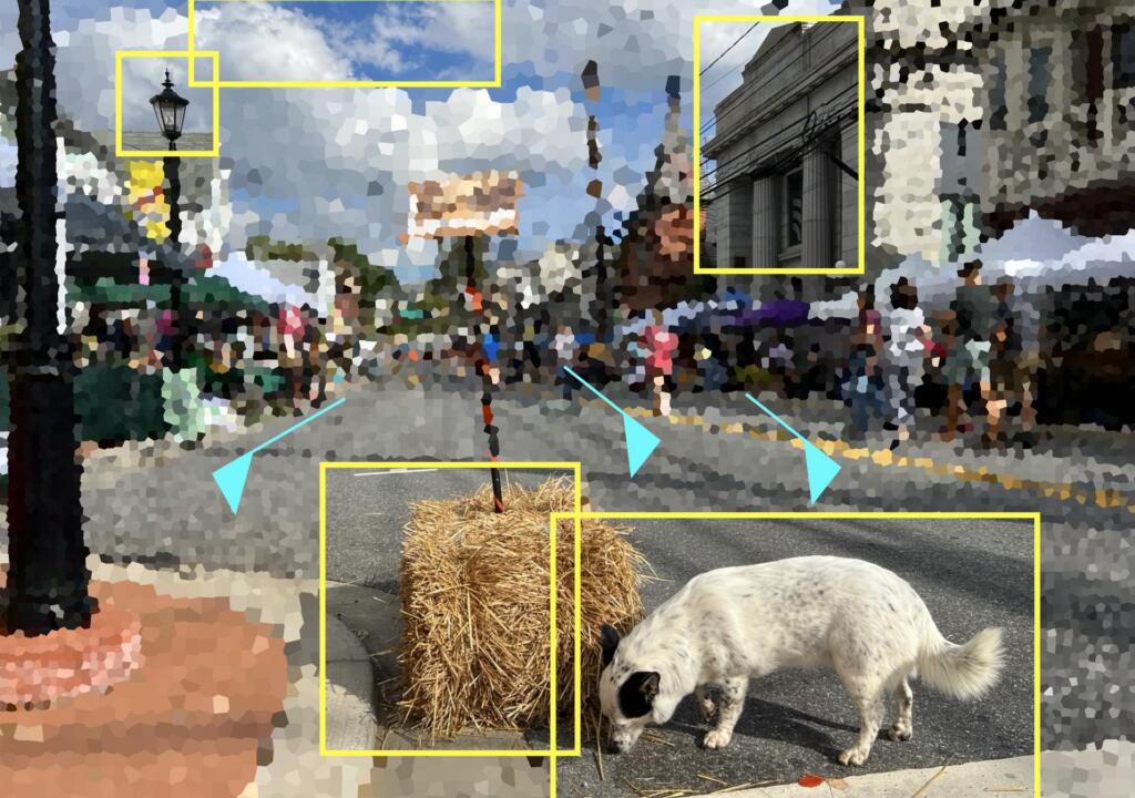 The image shows a pixelated image of a street. While it is heavily pixelated, you can make out lamposts, people walking on the sidewalks, and stalls/buildings that line wach side of the road. In the forefront, there is a stack of hay and a dog which is sniffing it. There are various yellow boxes outlining different parts of the image including: the light of a lamp post, the dog, a hay stack, and an old-style building.