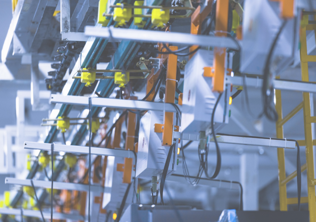 Close-up view of a fully automated line for the dynamic testing of cooling performance in a refrigerator manufacturing plant.