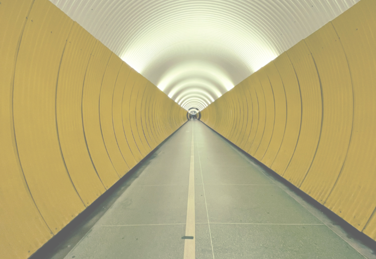 A long tunnel featuring bright yellow walls, creating a vibrant and inviting atmosphere.
